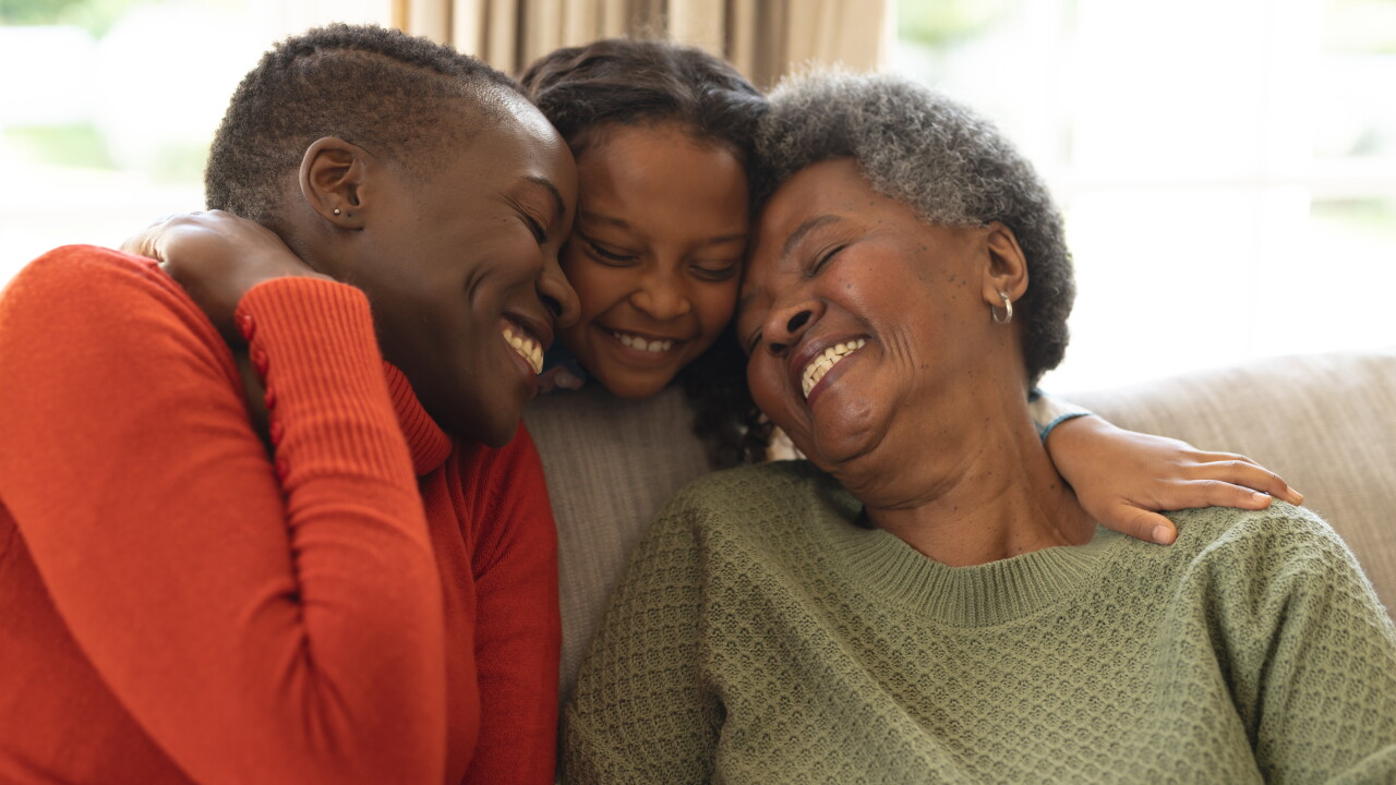 Three generations, hugging, smiling
