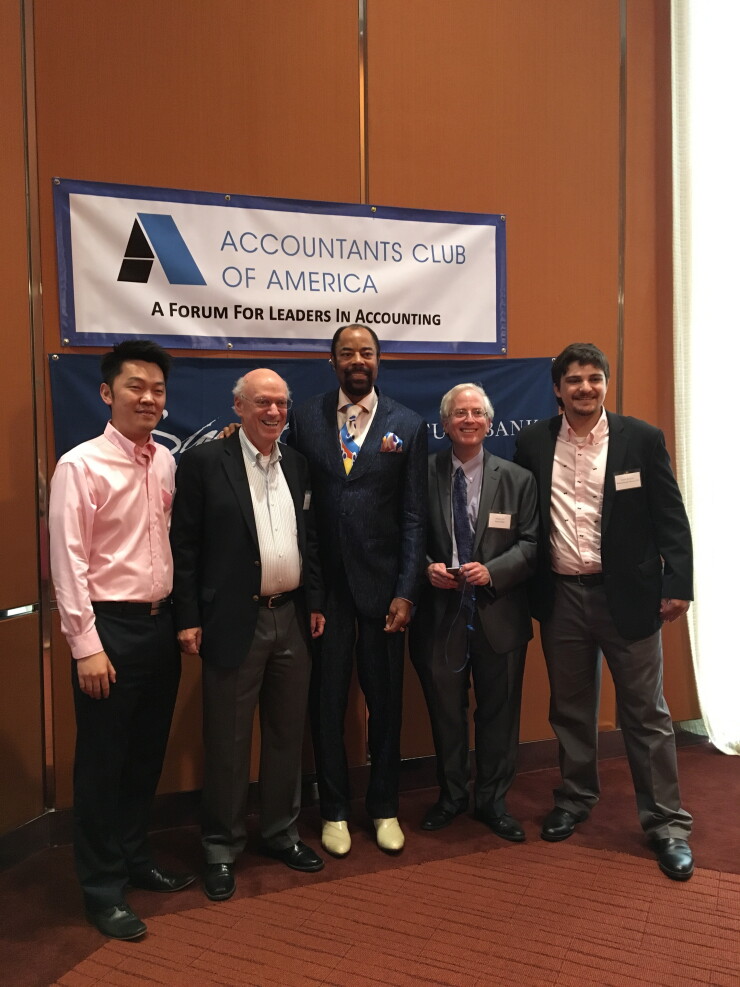 Walt Frazier at the Accountants Club of America, posing with Bin Qu (left) and Edward Mendlowitz of WithumSmith+Brown, Michael Cohn of Accounting Today, and Robert Reynolds of WithumSmith+Brown.
