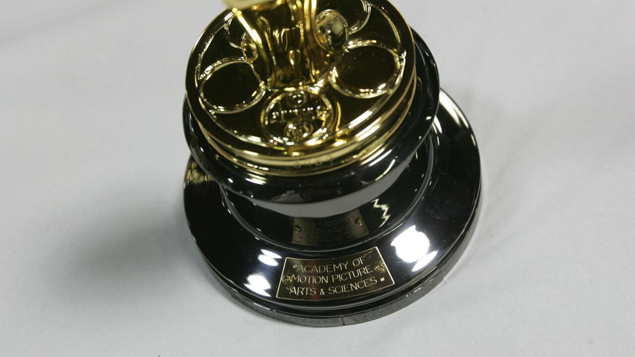 A small plate that reads "Academy of Motion Picture Arts & Sciences" is affixed to the bottom of an Oscar statuette as it's readied for shipping at the R.S. Owens factory in Chicago, Illinois, U.S., on Monday, Feb. 11, 2008.