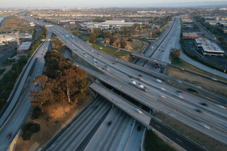 Vehicles travel along the Interstate 405 (I-405) and Interstate 110 (I-110) freeways in Gardena, California, U.S., on Friday, May 28, 2021. The days of bargain basement airfares are ending as the U.S. vaccine supply unleashes a wave of pent-up travel demand. Photographer: Bing Guan/Bloomberg