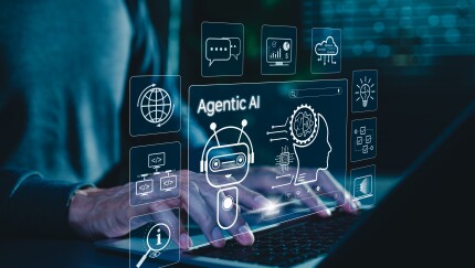 Man using laptop with robot, brain, agentic AI icons, automation, modern tech