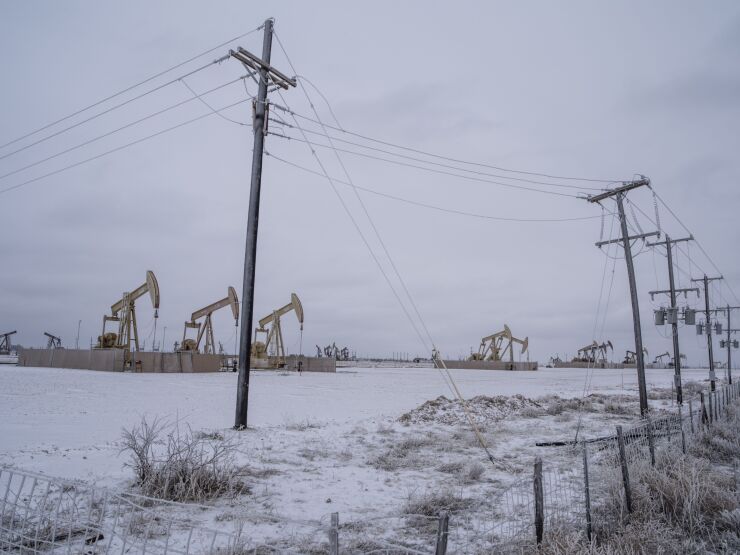 Pump jacks operate in the snow in the Permian Basin in Midland, Texas. The arctic freeze has forced the state's utility operator to implement rolling blackouts to prevent the electric grid from being overwhelmed.
