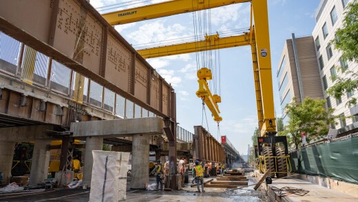 Construction workers operate a crane while working on the Park Avenue Viaduct Replacement