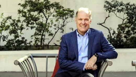 Mike Abbott sitting on a bench outside