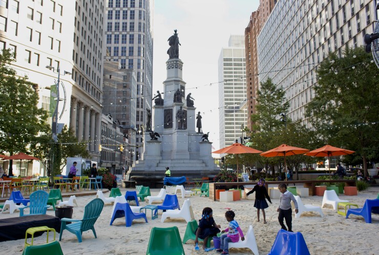 Children play in the sand at Campus Martius park in downtown Detroit, Michigan, U.S., on Monday, Oct. 5, 2015.