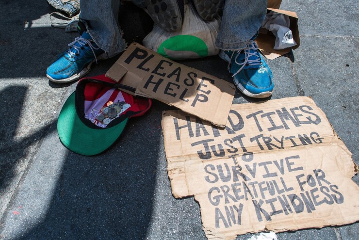Andrew Loy begs along a sidewalk in downtown San Francisco