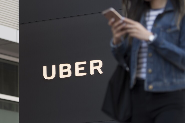 Uber signage and mobile phone user