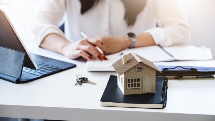 Entrepreneurs, business owners, accountants, real estate agents, focusing on tabletop home models with women using home equity budget calculators to assess their financial risks.