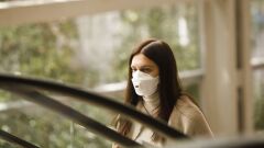 An airline passenger wears a protective face mask, manufactured by 3M Co., while passing through Ben Gurion International airport in Tel Aviv, Israel, on Tuesday, March 10, 2020. Israel expanded its 14-day quarantine policy to include arrivals from all countries, ramping up its efforts to beat back the spread of the coronavirus. Photographer: Kobi Wolf/Bloomberg