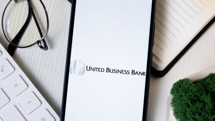 BayCom Logo on Phone Screen, United Business Bank Company Icon