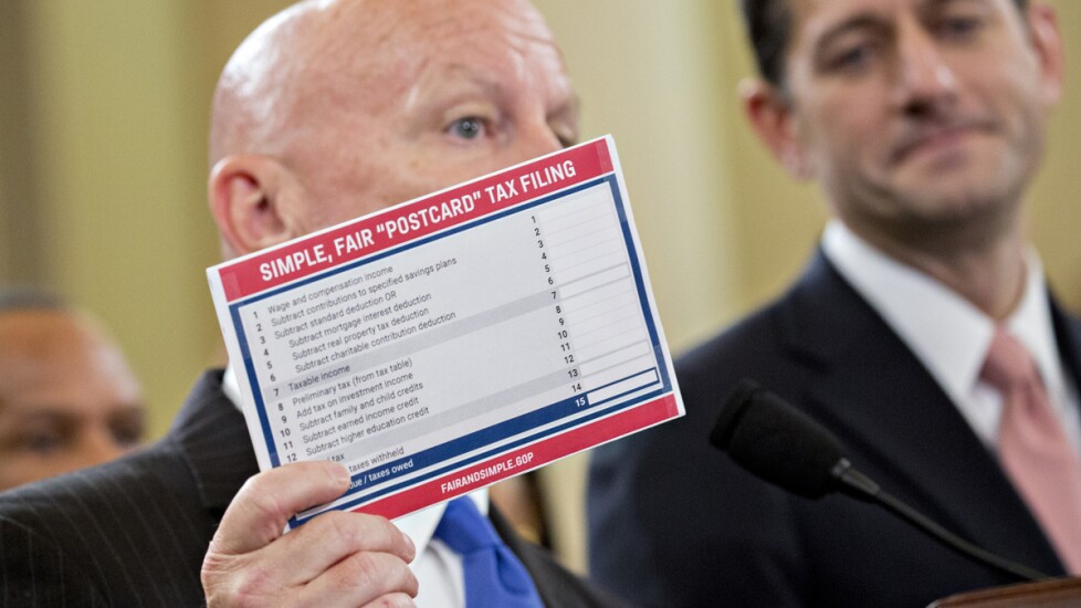House Ways and Means Committee chairman Kevin Brady, R-Texas, holds a sample postcard showing a simplified tax form as House Speaker Paul Ryan, R-Wis., looks on