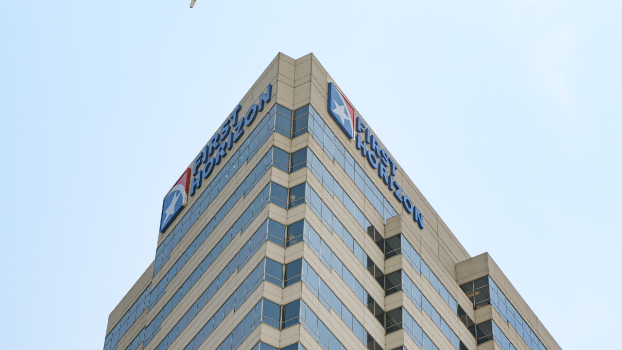 A plane flies over a First Horizon bank branch in downtown Nashville, Tennessee, US, on Tuesday, June 13, 2023.