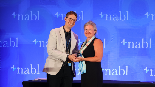 NABL President Matthias Edrich presents award to GFOA's Emily Brock