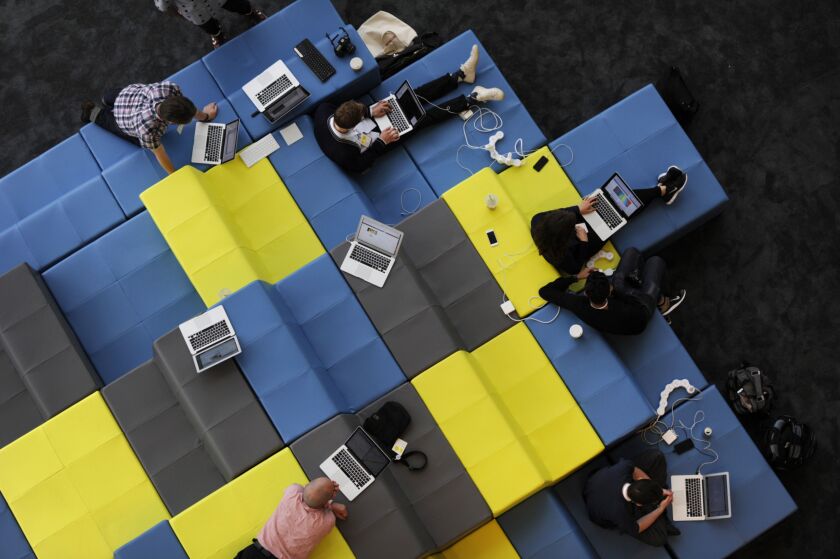 Attendees work on laptop computers during the Google I/O Annual Developers Conference in San Francisco.