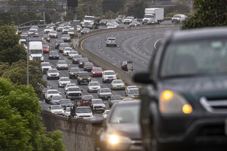 Cars on a road with five lanes of traffic.