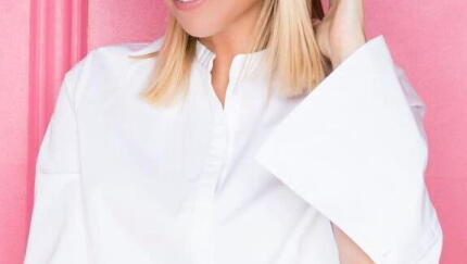 A woman smiling for a photo.