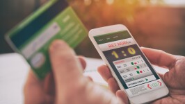 Man betting on sports with smartphone