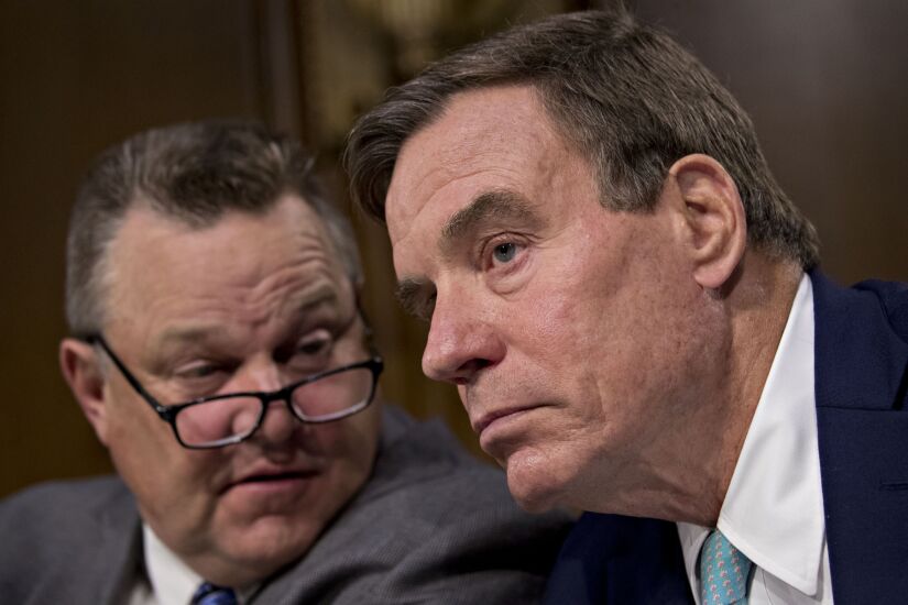 Senator Mark Warner, a Democrat from Virginia, right, talks to Senator Jon Tester, a Democrat from Montana