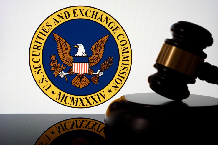 US Securities and Exchange Commission SEC logo seen on the screen and judges gavel next to it. Concept for lawsuit and litigation. Stafford, United Kingdom, April 28, 2024