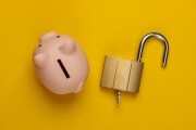 Piggy bank with lock on yellow background. Top view