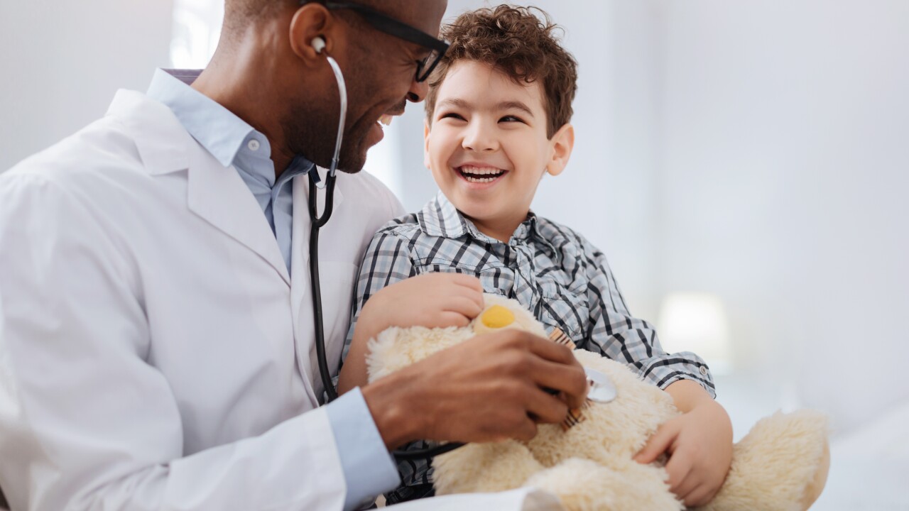 A doctor cares for a child patient.
