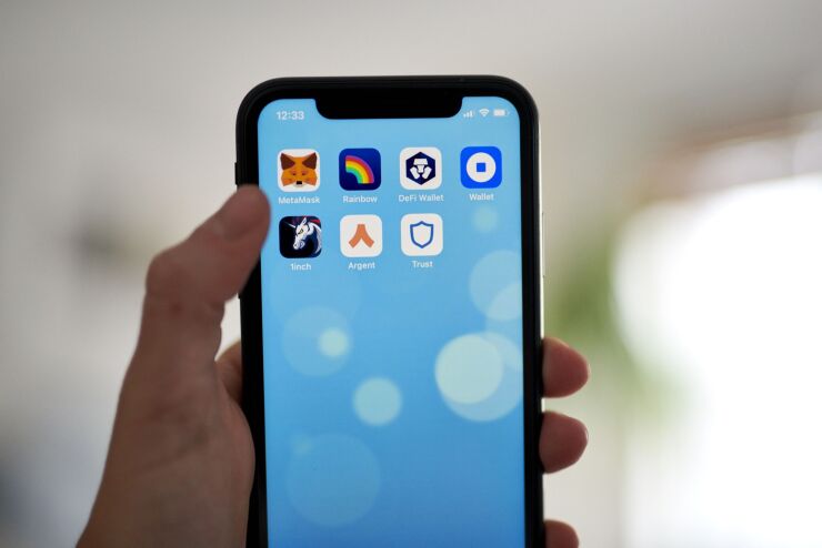 The Cryptocurrency wallet icons MetaMask, from top left, Rainbow, DeFi Wallet, Coinbase Wallet, 1inch, Argent, and Trust, on a smartphone arranged in the Brooklyn Borough of New York, U.S., on Thursday, July 29, 2021. Lending on cryptocurrency platforms rose 7.6% from last week to $29.40 billion, according to data compiled by DeFi Pulse. Photographer: Gabby Jones/Bloomberg