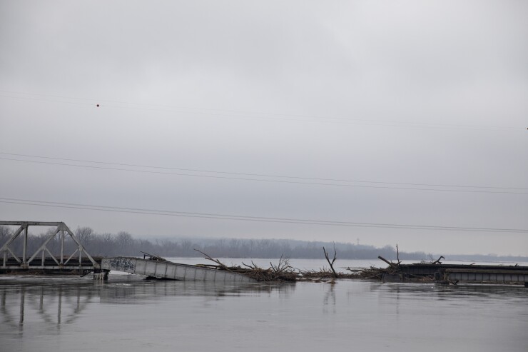 High water in the Platte River surrounds a collapsed section of a Burlington Northern Santa Fe LLC (BNSF) rail bridge in La Platte, Nebraska, U.S., on Sunday, March 24, 2019.
