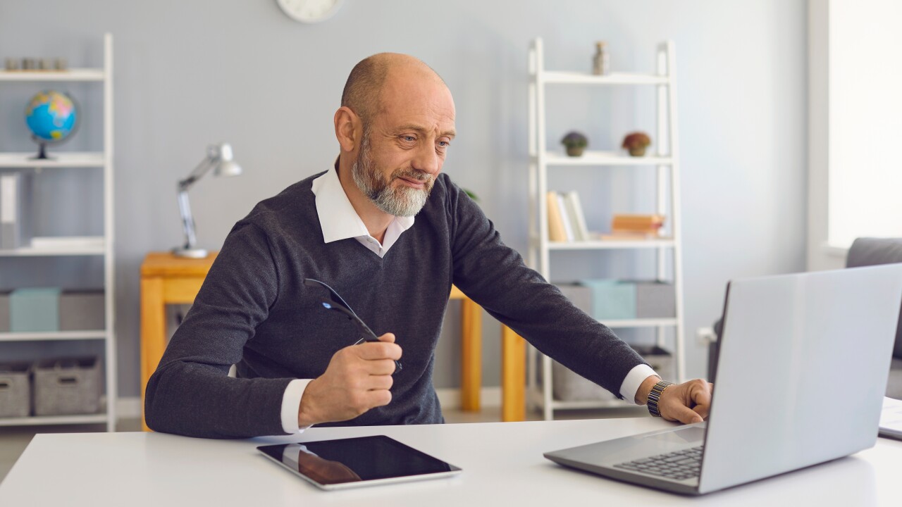 Man in office on laptop computer