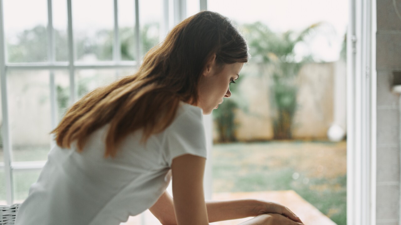 Woman sitting down looking sad