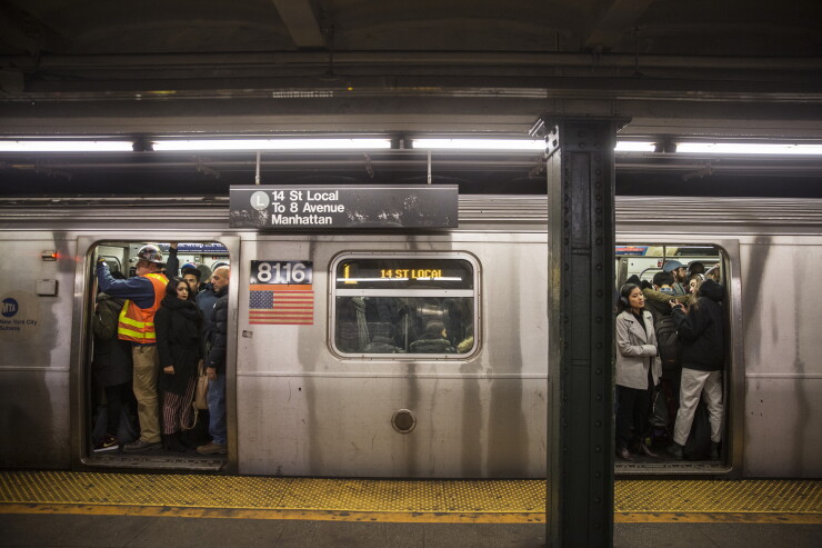 Commuters stand in a crowded L train subway car at the Bedford Avenue station in the Brooklyn borough of New York, U.S., on Thursday, Dec. 21, 2017.