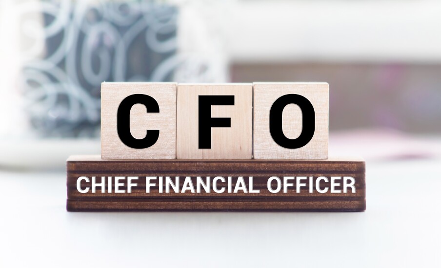 The letters CFO about a wooden sign that says "chief financial officer."