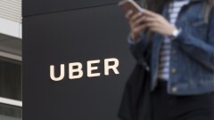 Uber signage and mobile phone user