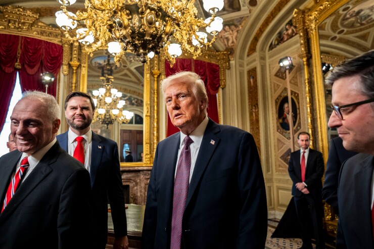 Donald Trump walking through an extravagant room next to vice president J.D. Vance.