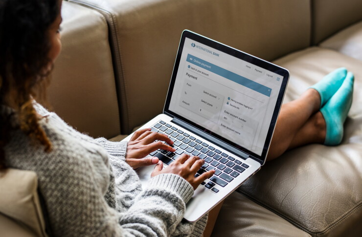 A woman using her laptop to bank online.