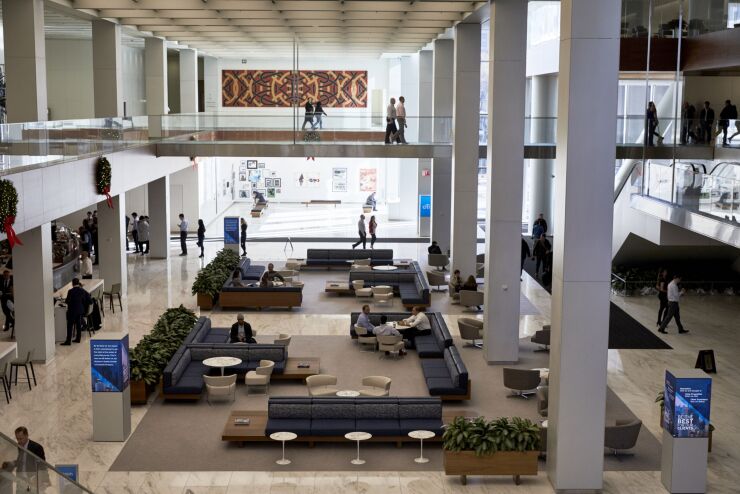 People sit in the Town Square meeting area at the new Citigroup headquarters in New York on Dec. 3, 2019.
