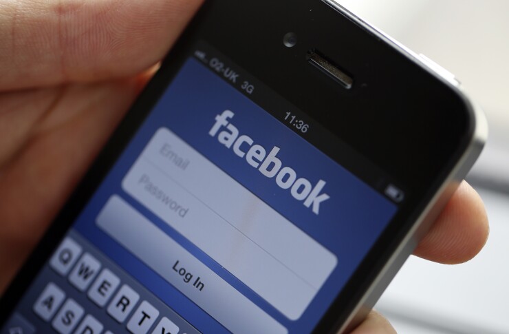 The login page for the Facebook Inc. social media site, is seen on an Apple Inc. iPhone 4 smartphone in this arranged photograph in London, U.K., on Wednesday, Aug. 29, 2012. Facebook Inc. is teaming up with architect Frank Gehry to expand its headquarters in Menlo Park, California with the project set to begin in spring 2013. Photographer: Chris Ratcliffe/Bloomberg