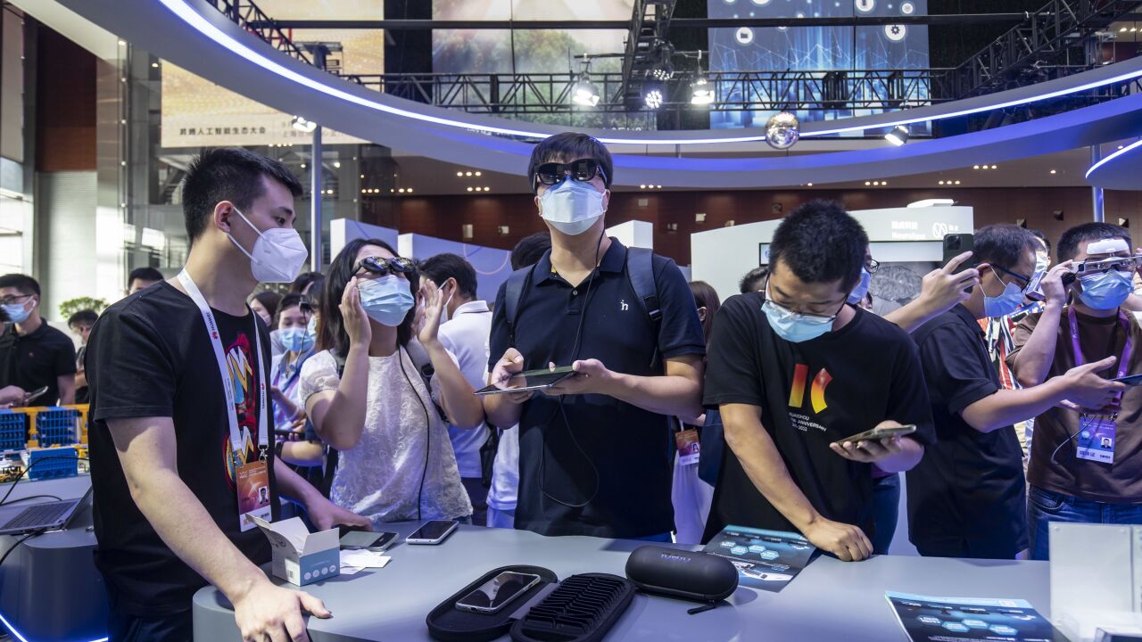 Visitors try on augmented reality (AR) glasses at the World Artificial Intelligence Conference (WAIC) in Shanghai, China, on Friday, Sept. 2, 2022. The conference runs through to Sept. 3. Photographer: Qilai Shen/Bloomberg
