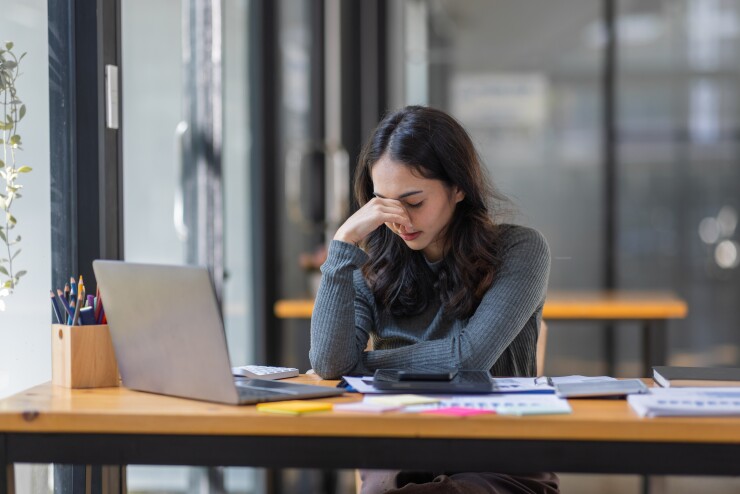 Woman looking down at her computer