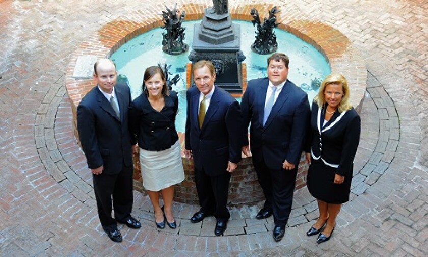 Tommy Boyd (center) says his five-member team, which includes his son and daughter, considered changing its name from Boyd Financial Group when they left Wells Fargo for the independent side of Raymond James. But history weighed on their thinking.