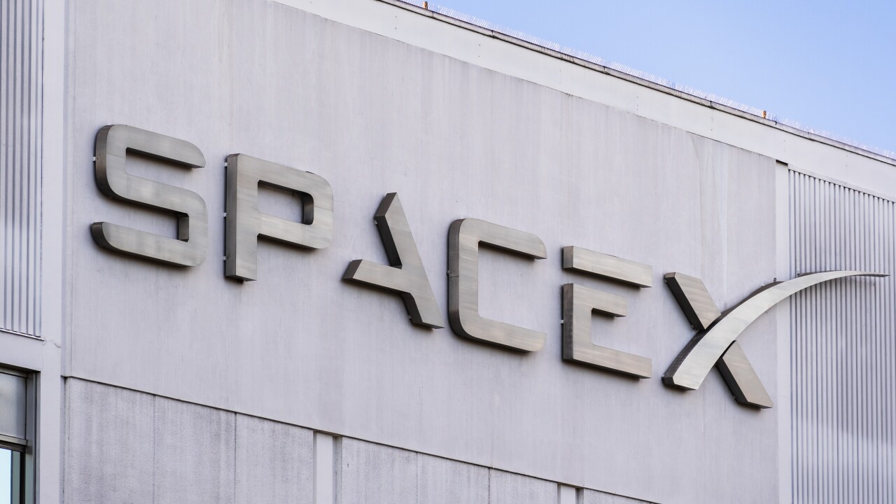 SpaceX logo on a gray building.