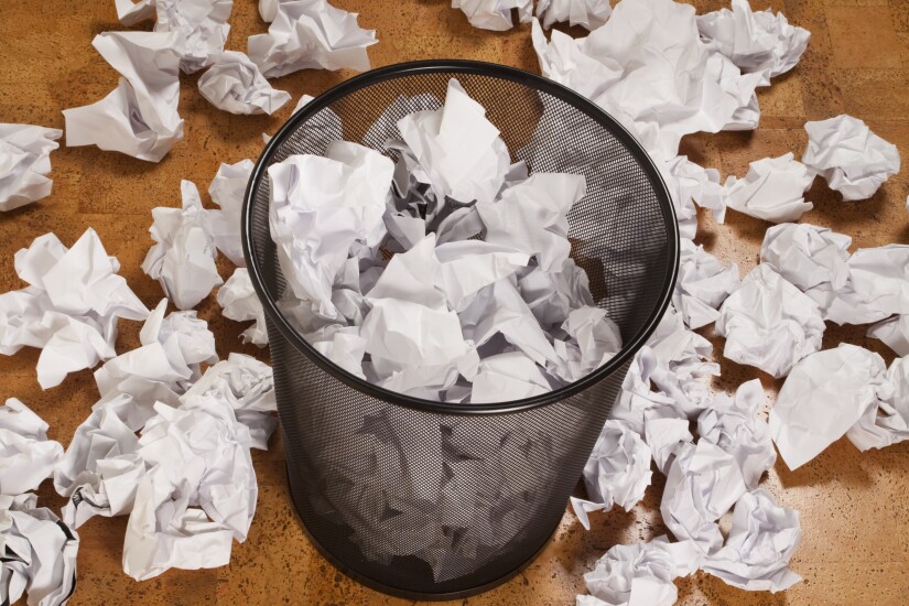 Garbage can with papers