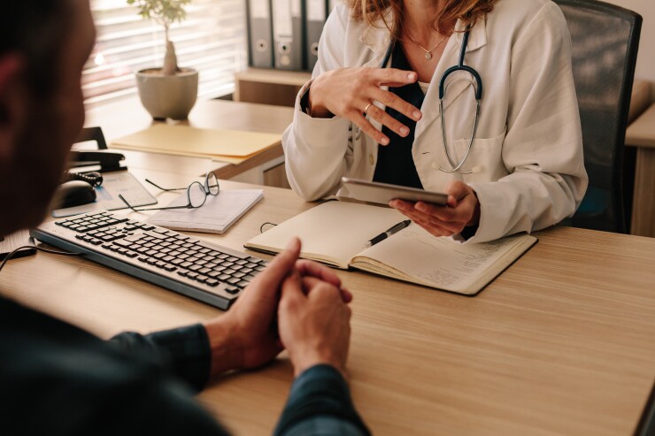 A man sitting in a doctor's appointment.