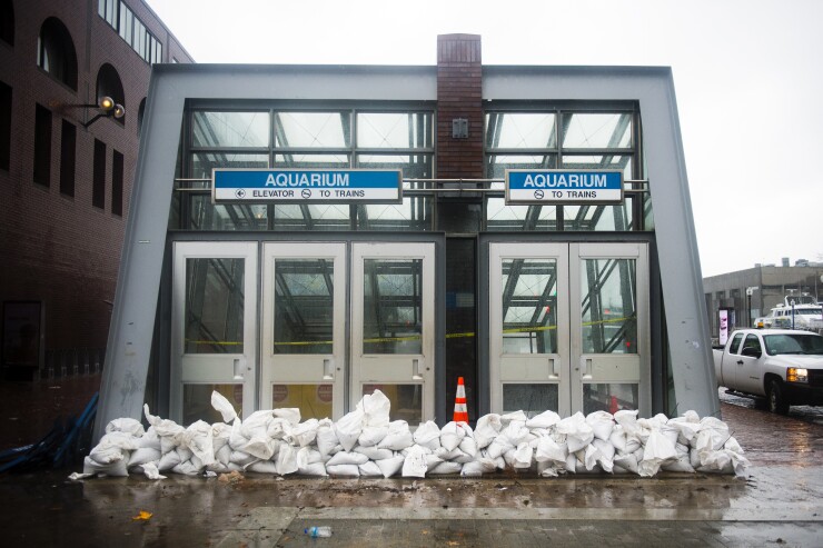 Sandbags line the entrance to the Aquarium MBTA during a storm in Boston, Massachusetts, U.S., on Friday, March 2, 2018. 