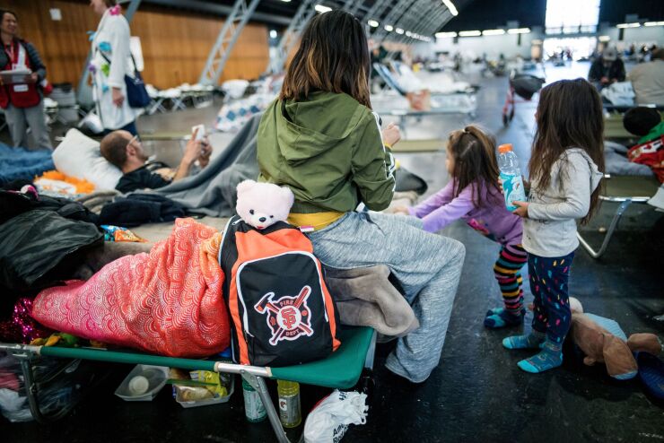 Wildfire evacuees sit inside an evacuation center in Santa Rosa, California, U.S., on Thursday, Oct. 31, 2019.