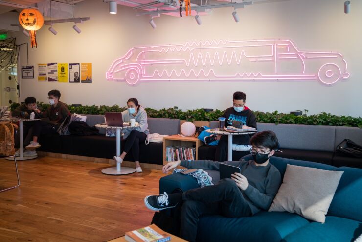 Students sit in the lounge at New York University Shanghai's Go Local campus at the WeWork Shinmay Union Square co-working space in Shanghai, China, on Tuesday, Nov. 3, 2020. NYU Shanghai is temporarily home to more than 2,800 additional students, most of them Chinese enrolled at the New York campus but unable to travel due to Covid-19. Photographer: Yan Cong/Bloomberg