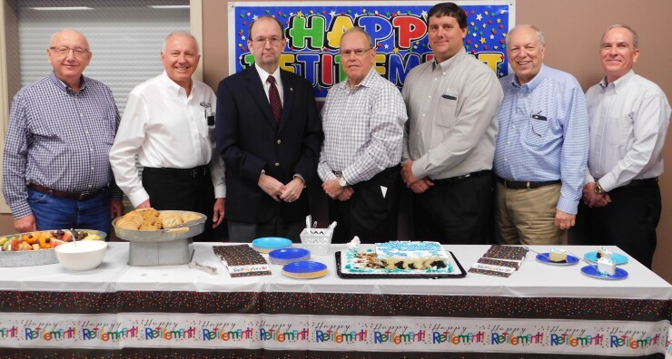 Retirement party for Bob Downs, CEO at Crane Credit Union in Odon, Ind. Pictured above, from left to right, are: David Frye, director; Kenny Greenwell, director; Gary Gray, chairman of the board; Bob Downs, Crane Credit Union outgoing president/CEO; Kevin Sparks, current Crane Credit Union president/CEO; Dale Padgett, director; and Bruce Cummings, director.
