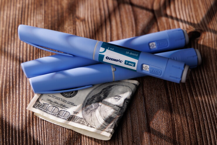 GLP-1 medication with money underneath; expensive