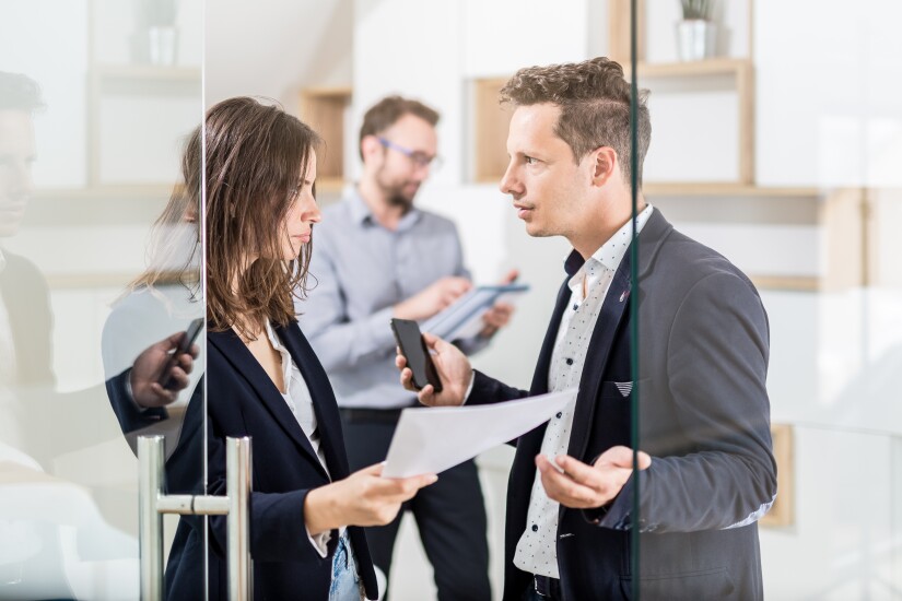 Two employees having a strained conversation in the office