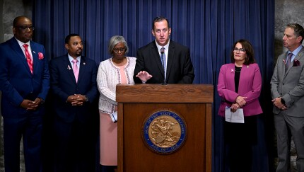 Sen. Michael Hastings speaking at podium