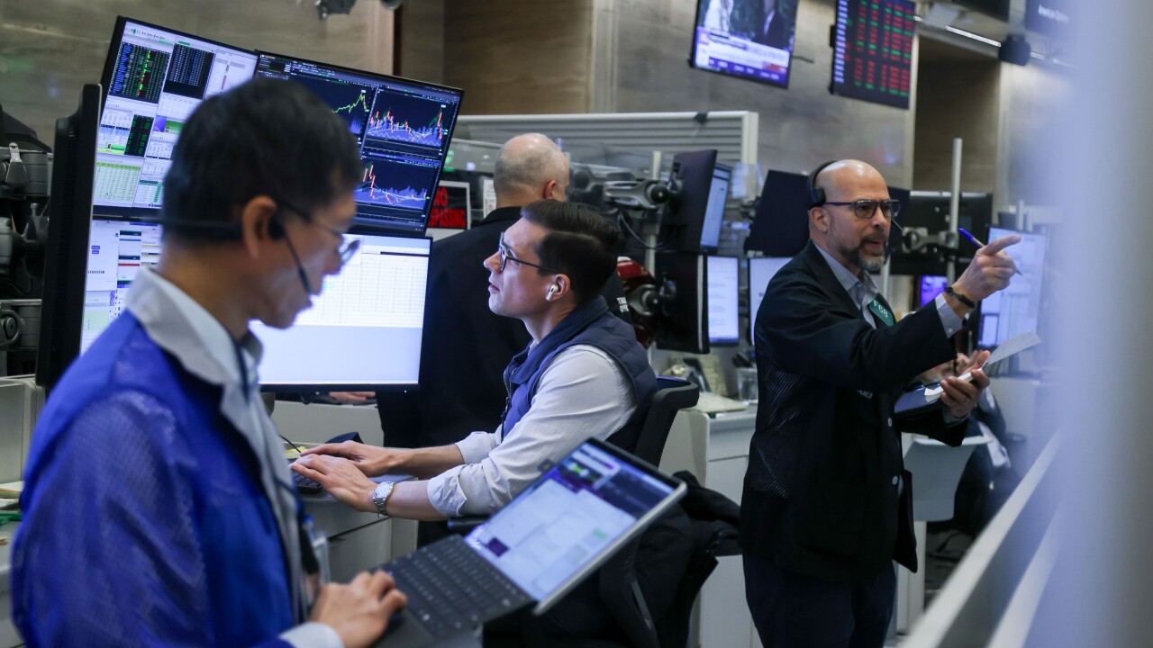 Traders work on the floor at the New York Stock Exchange. Photographer